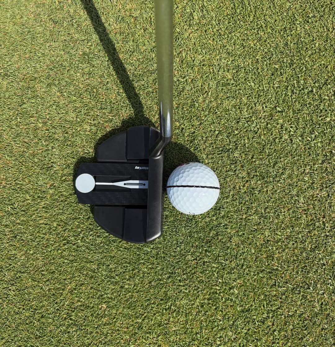 Golfer practicing putting alignment with Putter Key before a tournament